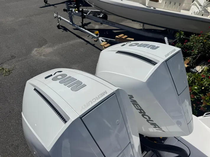  Yacht Photos Pics Twin Mercury outboard engines on a 2026 Blackfin 272 DC boat, parked on a trailer.