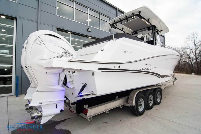  Yacht Photos Pics 2023 Jeanneau Leader 10.5 CC boat on trailer, parked outside a building.