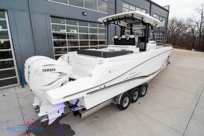  Yacht Photos Pics 2023 Jeanneau Leader 10.5 CC boat with Yamaha engines, parked outside a building.