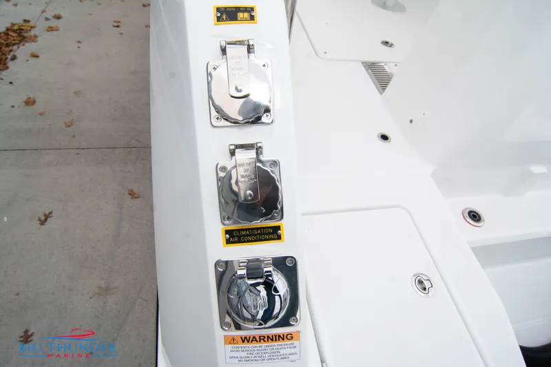  Yacht Photos Pics 2023 Jeanneau Leader 10.5 CC boat deck with utility access panels and warning labels.