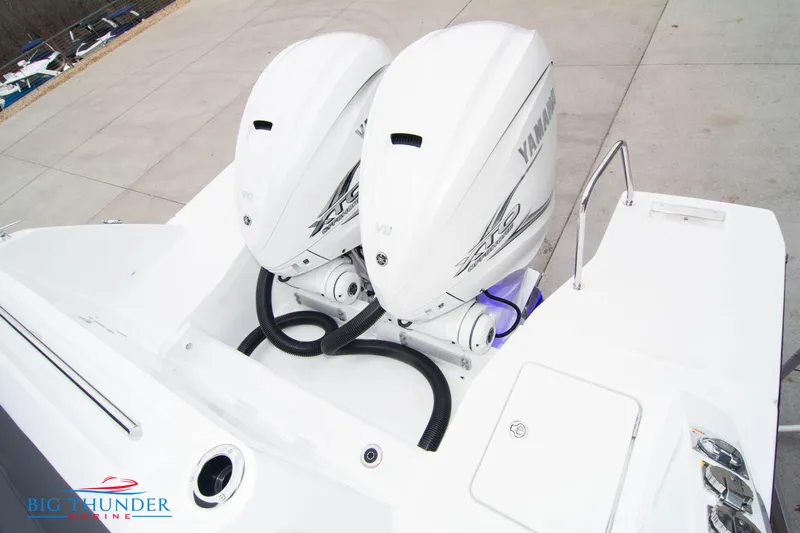  Yacht Photos Pics 2023 Jeanneau Leader 10.5 CC with dual Yamaha outboard engines, docked on concrete.