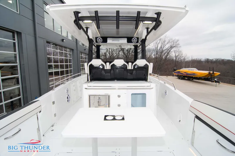  Yacht Photos Pics 2023 Jeanneau Leader 10.5 CC boat interior with seating and table, docked at marina.