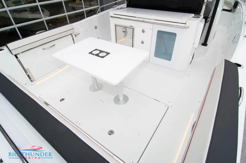  Yacht Photos Pics 2023 Jeanneau Leader 10.5 CC boat deck with seating and table.