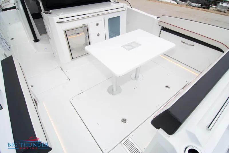  Yacht Photos Pics 2023 Jeanneau Leader 10.5 CC boat interior with seating and table.