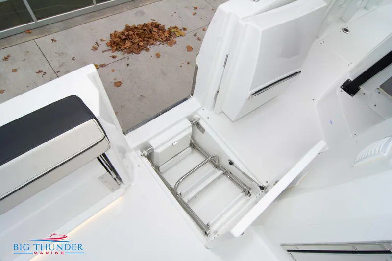  Yacht Photos Pics 2023 Jeanneau Leader 10.5 CC boat interior with open storage compartment.