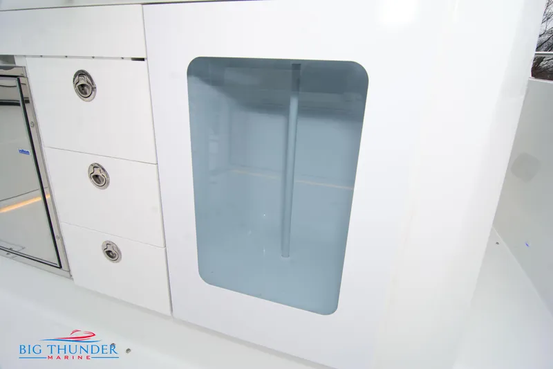  Yacht Photos Pics 2023 Jeanneau Leader 10.5 CC interior storage with drawers and glass panel.