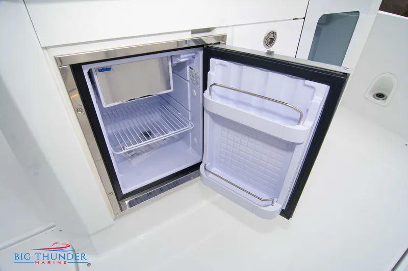  Yacht Photos Pics 2023 Jeanneau Leader 10.5 CC boat refrigerator, open with empty shelves.