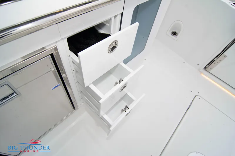  Yacht Photos Pics 2023 Jeanneau Leader 10.5 CC interior with open storage drawers and sleek design.