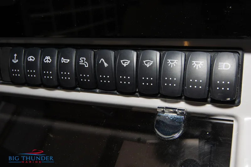  Yacht Photos Pics Control panel switches on a 2023 Jeanneau Leader 10.5 CC boat dashboard.