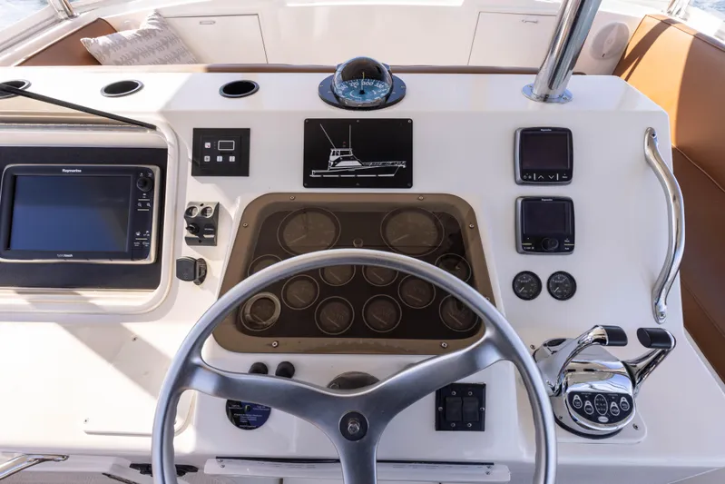 Lucky Marlin Yacht Photos Pics 1987 Ocean Yachts Convertible helm with steering wheel, navigation instruments, and control panel.