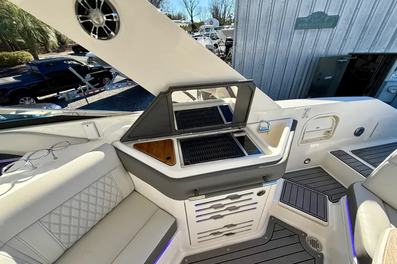  Yacht Photos Pics 2021 Sea Ray SLX 310 Outboard interior with grill and seating area.