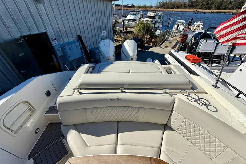  Yacht Photos Pics 2021 Sea Ray SLX 310 Outboard with luxurious seating at a marina dock.