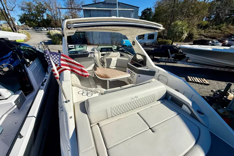  Yacht Photos Pics 2021 Sea Ray SLX 310 Outboard boat with American flag, docked outdoors.