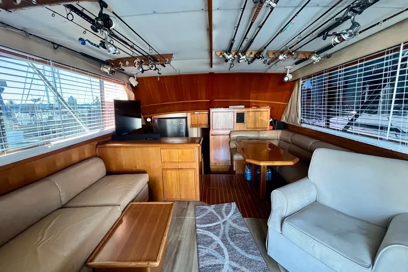 Precision Fisher Yacht Photos Pics Interior of 1988 Post 46 Sportfish yacht with cozy seating and fishing rods.