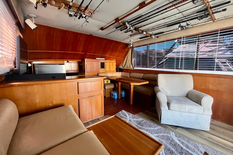 Precision Fisher Yacht Photos Pics Interior of 1988 Post 46 Sportfish yacht with fishing rods and cozy seating.