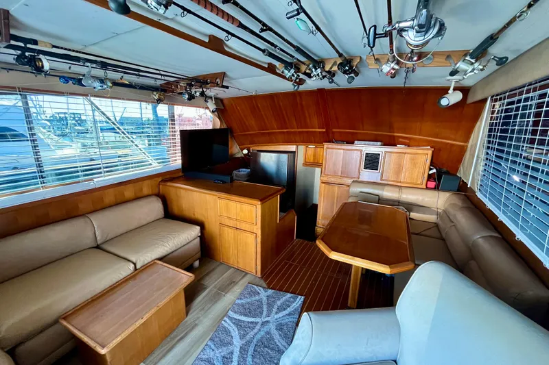 Precision Fisher Yacht Photos Pics Interior of 1988 Post 46 Sportfish yacht with cozy seating and fishing rods.