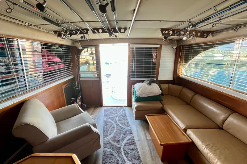 Precision Fisher Yacht Photos Pics Interior of 1988 Post 46 Sportfish yacht with seating, fishing rods, and natural light.
