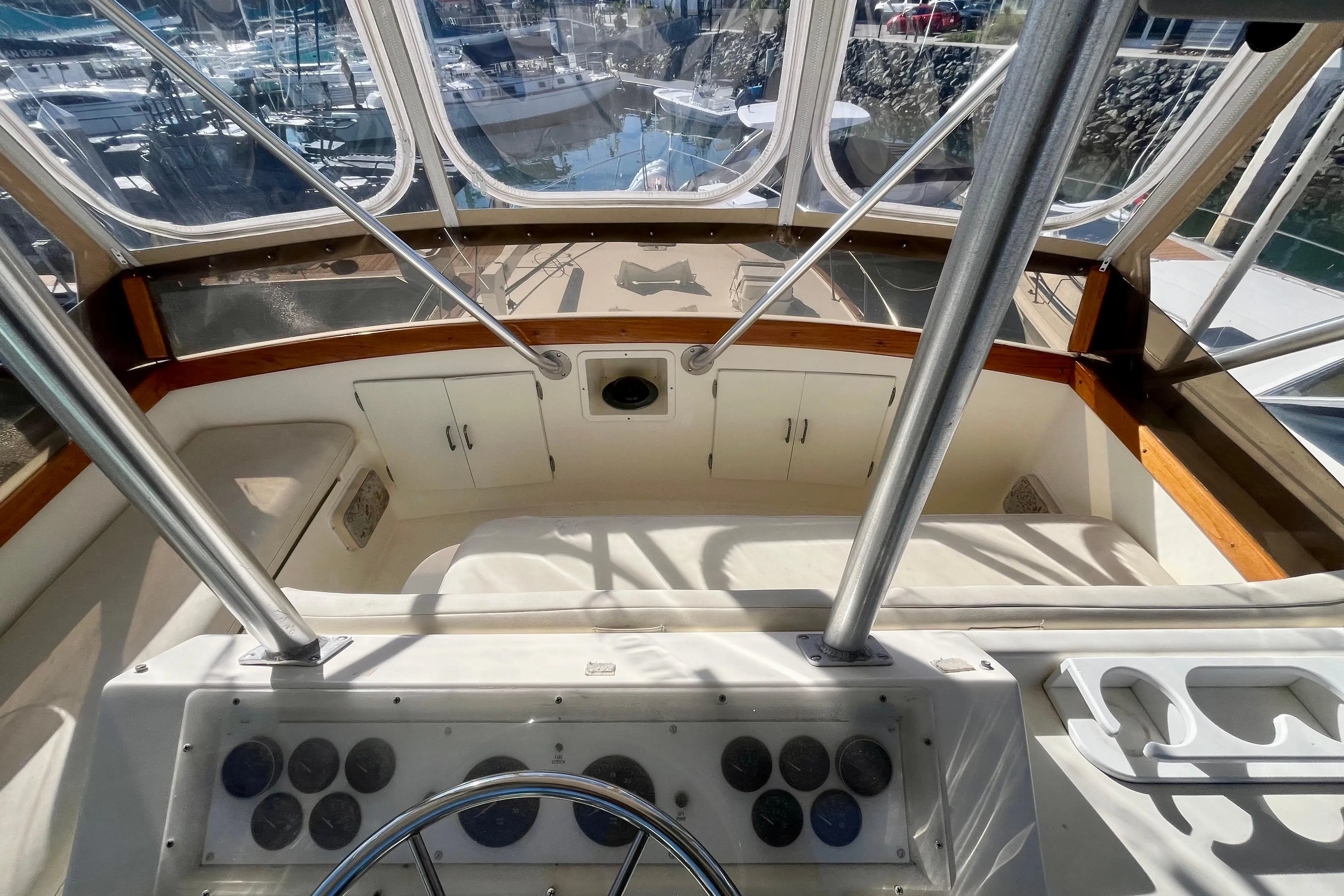 1988 Post 46 Sportfish boat cockpit with steering wheel and control panel.