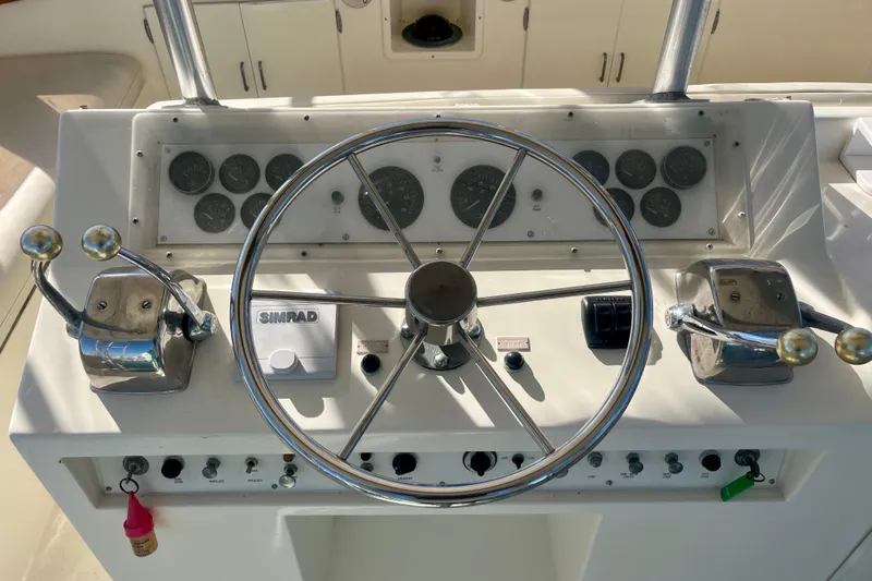 Precision Fisher Yacht Photos Pics Control panel of a 1988 Post 46 Sportfish boat with steering wheel and gauges.