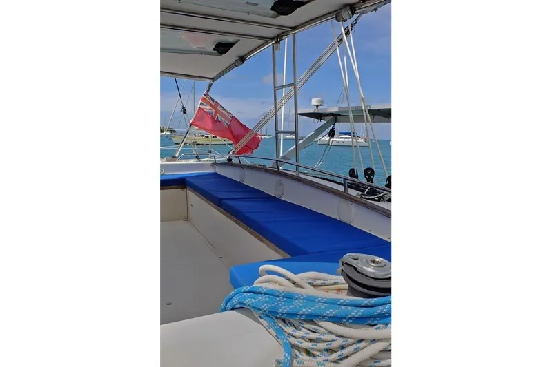 Delphine Yacht Photos Pics Outremer 45 catamaran deck with blue seating and nautical ropes, 2003 model.