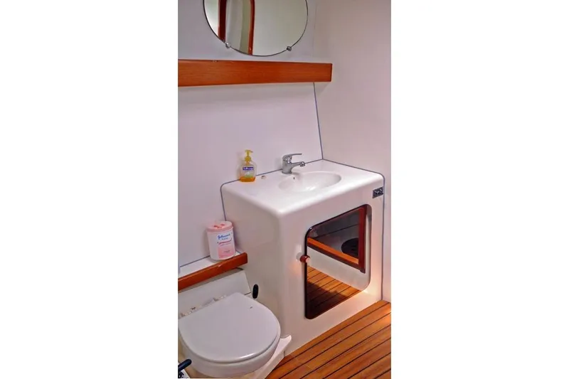 Delphine Yacht Photos Pics Bathroom interior of 2003 Outremer 45 yacht with sink and toilet.