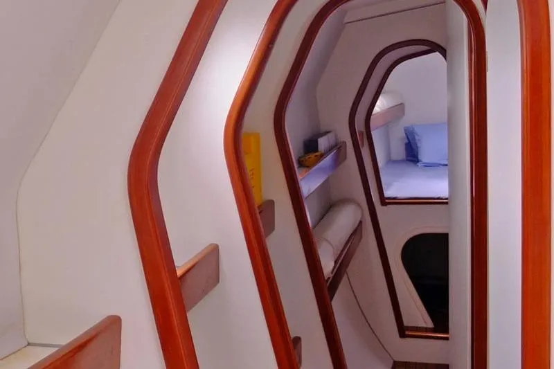 Delphine Yacht Photos Pics Interior of 2003 Outremer 45 yacht, featuring wooden trim and cozy sleeping quarters.