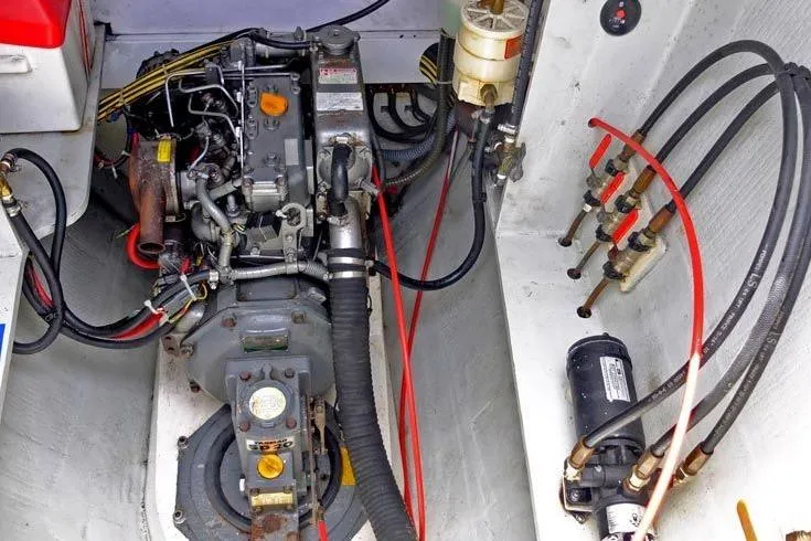 Delphine Yacht Photos Pics Engine compartment of a 2003 Outremer 45 catamaran, showcasing mechanical components and wiring.