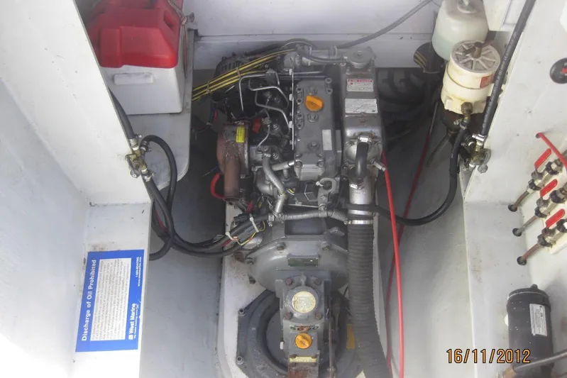 Delphine Yacht Photos Pics Engine compartment of a 2003 Outremer 45 catamaran, showing mechanical components and wiring.