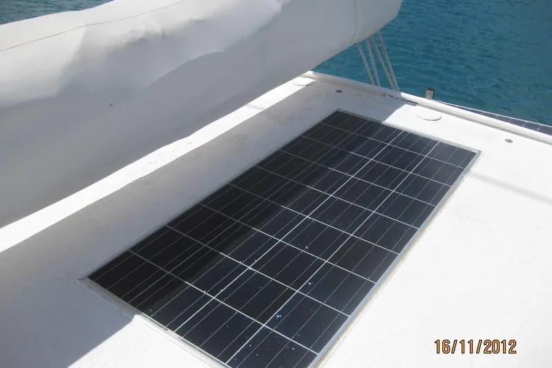 Delphine Yacht Photos Pics Solar panel on 2003 Outremer 45 catamaran deck, near water.