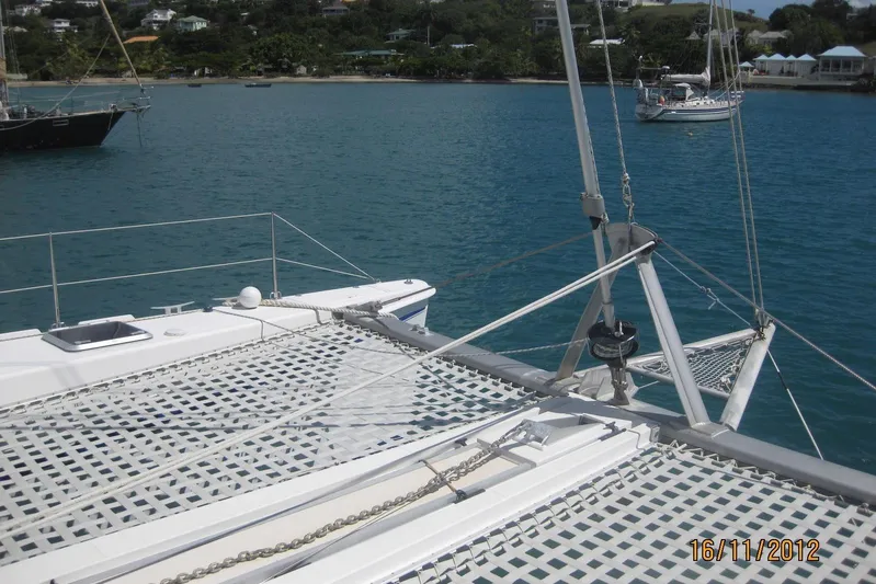 Delphine Yacht Photos Pics Outremer 45 catamaran on calm waters, showcasing deck and rigging, 2003 model.