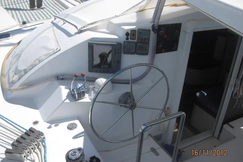 Delphine Yacht Photos Pics Cockpit of 2003 Outremer 45 sailboat with steering wheel and navigation instruments.