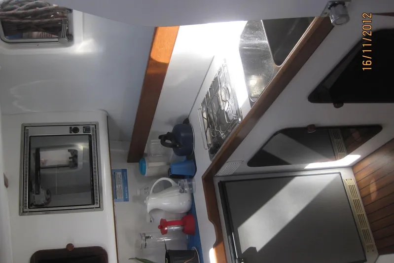 Delphine Yacht Photos Pics Interior of 2003 Outremer 45 yacht kitchen with stove, fridge, and appliances.