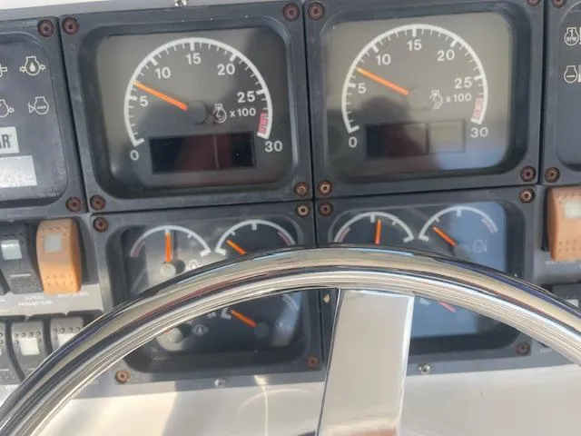 All Hans In Yacht Photos Pics Control panel of a 1999 Riviera SF boat with gauges and steering wheel.