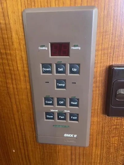 All Hans In Yacht Photos Pics 1999 Riviera SF SMX II control panel with temperature and fan settings on wooden surface.