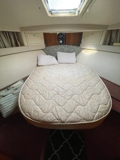 All Hans In Yacht Photos Pics 1999 Riviera SF boat cabin with cozy bed and overhead skylight.