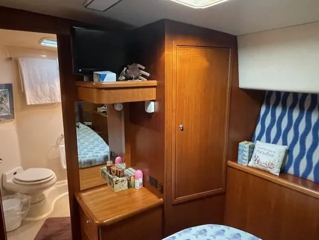 All Hans In Yacht Photos Pics Cozy 1999 Riviera SF cabin interior with wooden furnishings and bathroom.