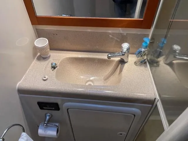 All Hans In Yacht Photos Pics Compact beige bathroom sink with mirror in 1999 Riviera SF model.