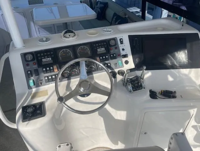 All Hans In Yacht Photos Pics 1999 Riviera SF boat cockpit with steering wheel, gauges, and control panel.