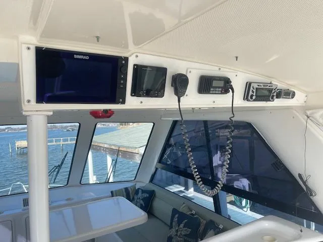 All Hans In Yacht Photos Pics Interior of a 1999 Riviera SF boat with navigation equipment and seating area.