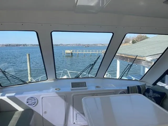 All Hans In Yacht Photos Pics Interior view of 1999 Riviera SF boat overlooking serene waterfront and dock.