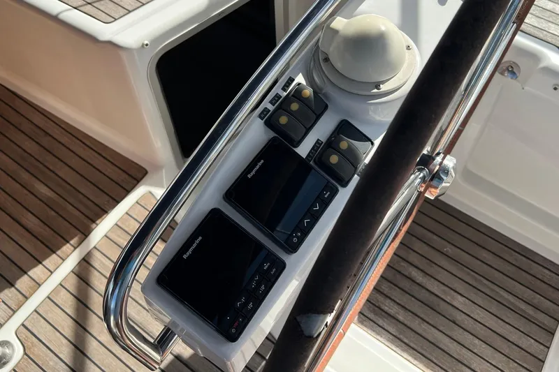 Saba Yacht Photos Pics Control panel of 2013 Jeanneau 57 yacht with Raymarine displays and wooden deck.