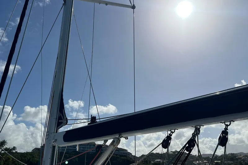 Saba Yacht Photos Pics Sailboat mast and rigging of 2013 Jeanneau 57 under bright sun and clear sky.