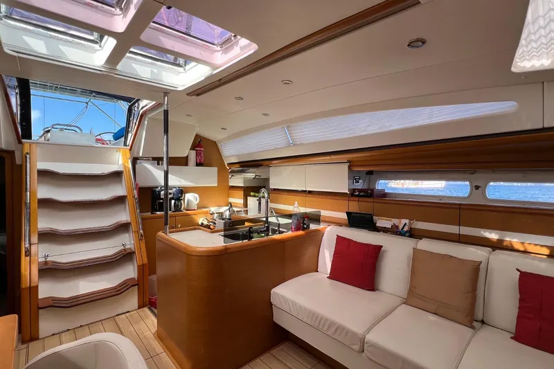 Saba Yacht Photos Pics Luxurious interior of 2013 Jeanneau 57 yacht with modern kitchen and comfortable seating.