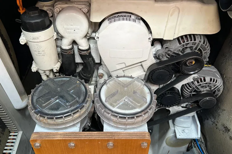 Saba Yacht Photos Pics Engine compartment of a 2013 Jeanneau 57 sailboat, featuring mechanical components and belts.