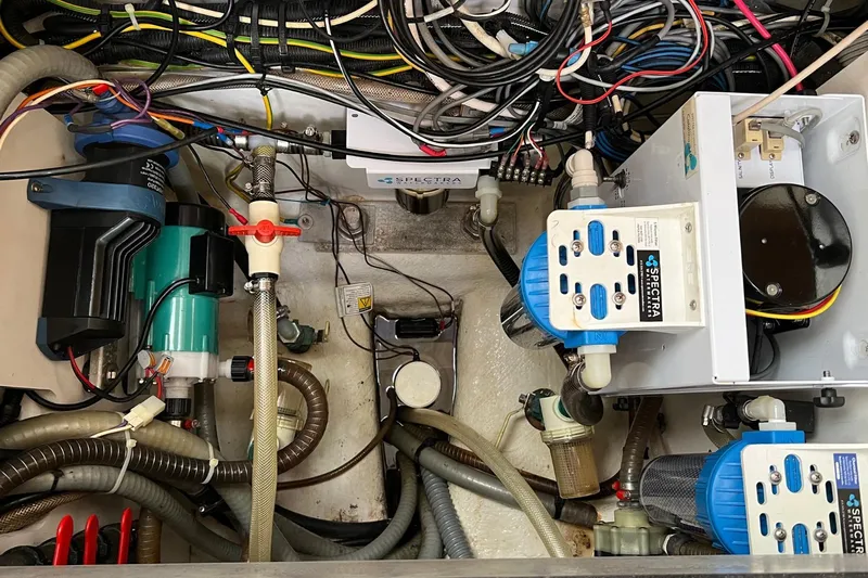 Saba Yacht Photos Pics Engine room of a 2013 Jeanneau 57 yacht with complex wiring and equipment.