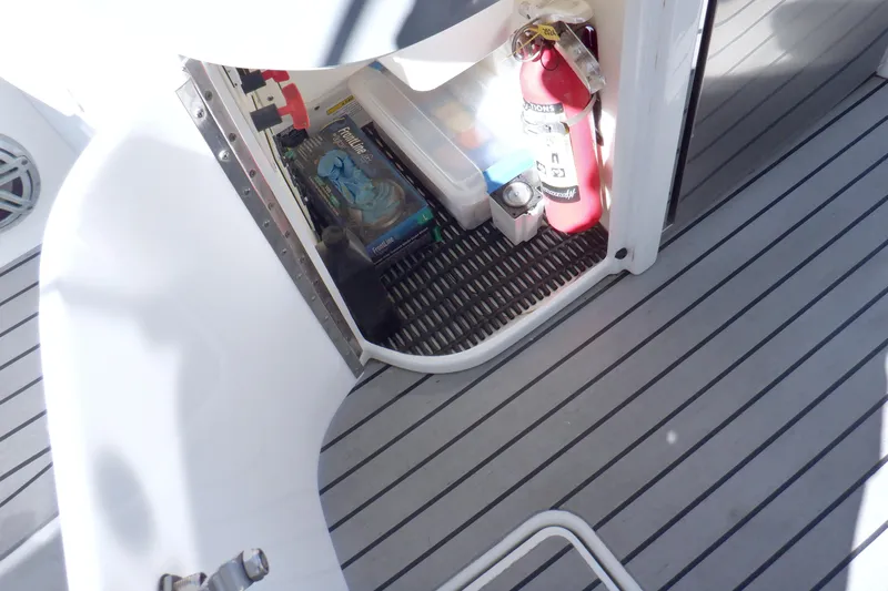Ship Faced Yacht Photos Pics Storage compartment on 2015 Formula 350 Crossover Bowrider with fire extinguisher and supplies.