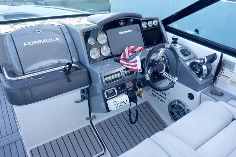 Ship Faced Yacht Photos Pics 2015 Formula 350 Crossover Bowrider cockpit with steering wheel and navigation controls.