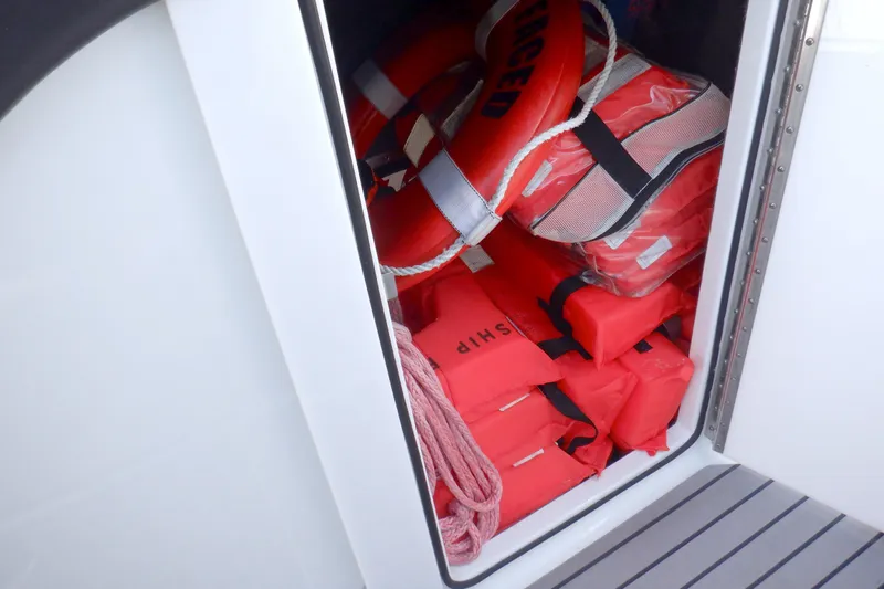 Ship Faced Yacht Photos Pics Storage compartment with life jackets and lifebuoys on a 2015 Formula 350 Crossover Bowrider.