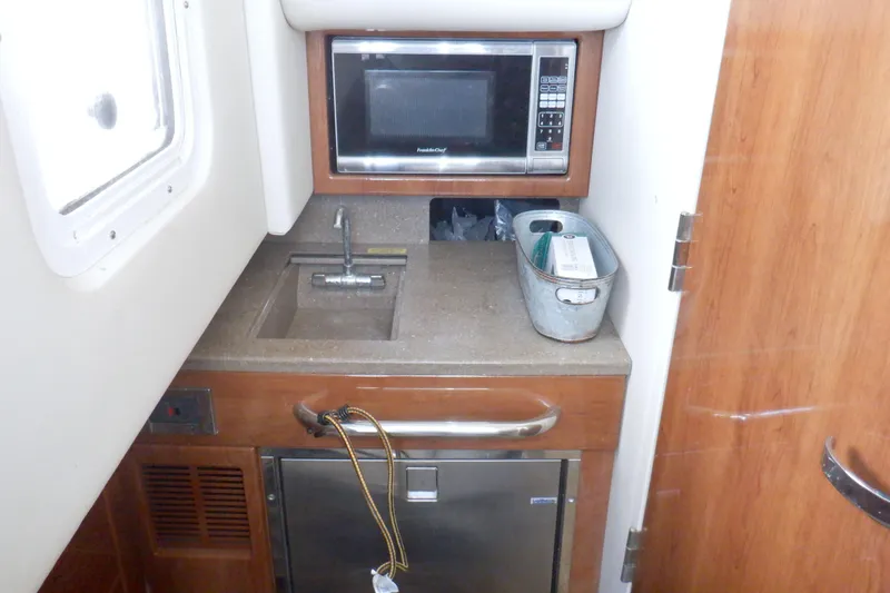 Ship Faced Yacht Photos Pics 2015 Formula 350 Crossover Bowrider kitchenette with microwave, sink, and storage.