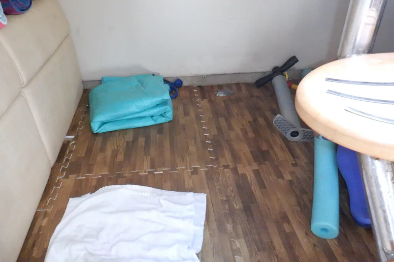 Ship Faced Yacht Photos Pics Interior of 2015 Formula 350 Crossover Bowrider with wooden flooring and scattered items.